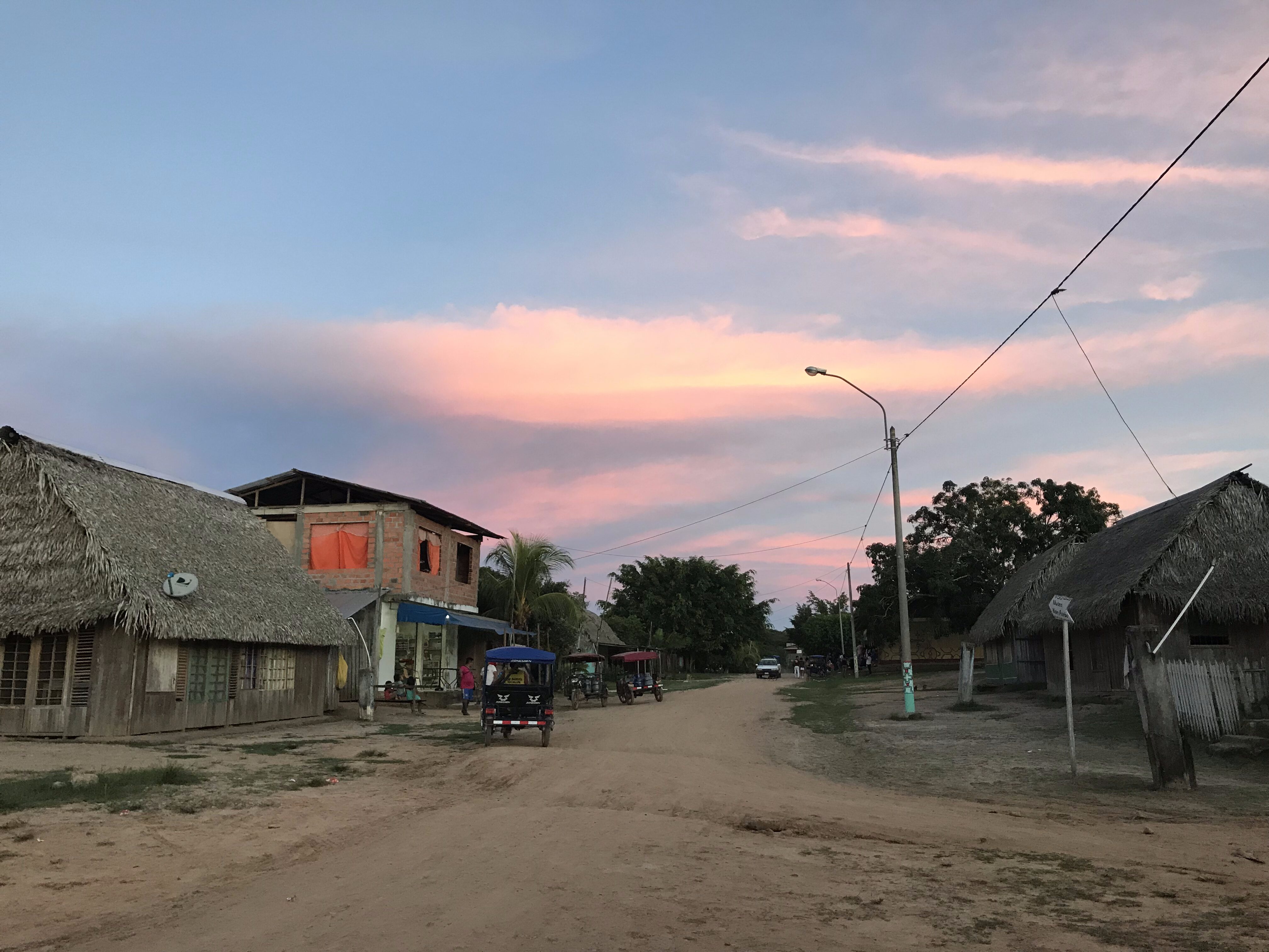 A quiet jungle town surrounded by dense rainforest, evoking the mystical and ancestral roots of brujería.